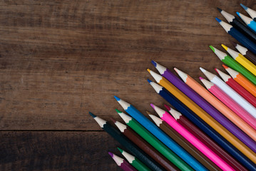 Obraz premium multicolored pencil on a wooden table. art education and creativity concept