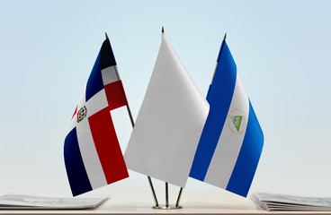 Flags of Dominican Republic and Nicaragua with a white flag in the middle