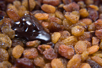 pile of raisins covered with melt chocolate. healthy food concept