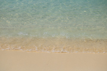 Soft Wave Of Blue Ocean On Sandy Beach. Background. Selective focus.