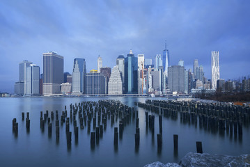 Naklejka premium Skyline of Manhattan on cloudy sky as background