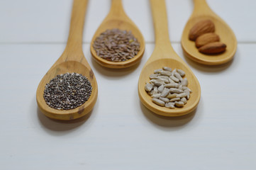 four wooden spoons with seeds close up