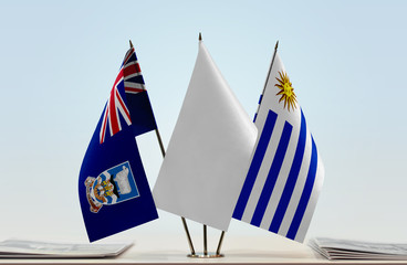 Flags of Falkland Islands and Uruguay with a white flag in the middle
