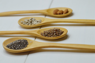 four wooden spoons with seeds side view
