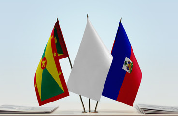 Flags of Grenada and Haiti with a white flag in the middle