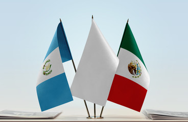 Flags of Guatemala and Mexico with a white flag in the middle