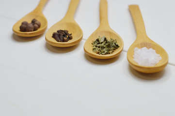 Fototapeta na wymiar wooden spoons arrangement with spices perspective view