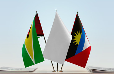 Flags of Guyana and Antigua and Barbuda with a white flag in the middle