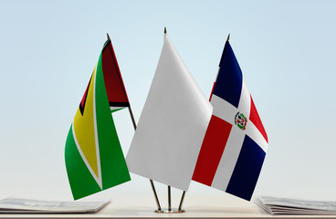 Flags of Guyana and Dominican Republic with a white flag in the middle