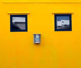 Obraz na płótnie Canvas Orange wall with two windows