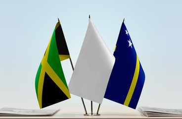 Flags of Jamaica and Curacao with a white flag in the middle