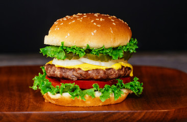 Close up delicious fresh burger o wooden board