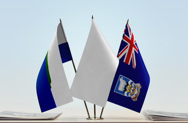 Flags of Navassa Island and Falkland Islands with a white flag in the middle