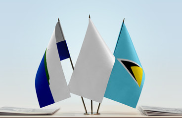 Flags of Navassa Island and Saint Lucia with a white flag in the middle