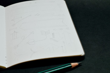 notebook with pencil sketches of arrows.jpg