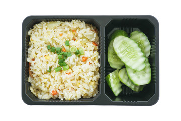 Fried rice with egg and sliced cucumber in black plastic tray isolated on white background , included clipping path