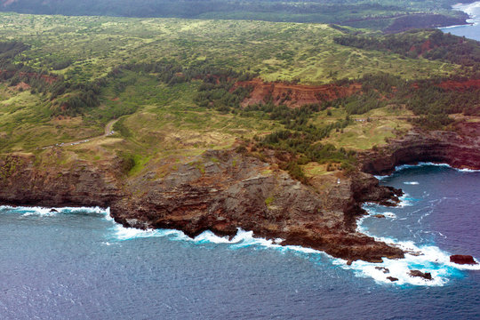 Aerial view of the coast of the island of Maui in Hawaii, shot from a small, low-flying prop plane
