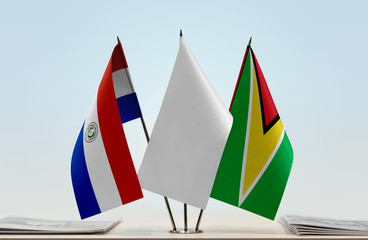 Flags of Paraguay and Guyana with a white flag in the middle