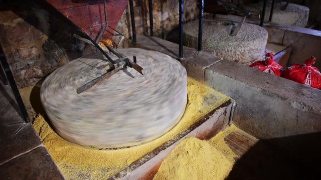 Old water powered working ancient stone mill for flour