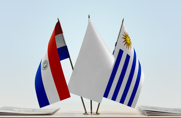 Flags of Paraguay and Uruguay with a white flag in the middle