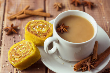 Indian tea masala with spices in white cup, Indian food on wooden table