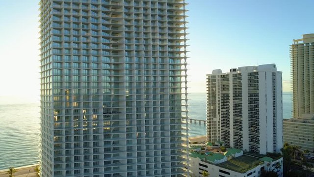Bright morning sun and Florida condominiums on the ocean 4k 24p