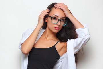 young girl in stylish glasses on a light background