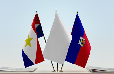 Flags of Saba and Haiti with a white flag in the middle