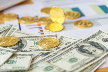 Bitcoin gold coin in dollars close up,Golden Bitcoins on US dollars for background. Bitcoin digital currency close-up. New Virtual money concept. Crypto currency top view..