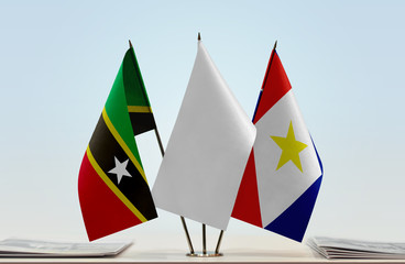 Flags of Saint Kitts and Nevis and Saba with a white flag in the middle