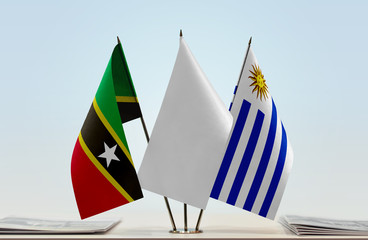 Flags of Saint Kitts and Nevis and Uruguay with a white flag in the middle