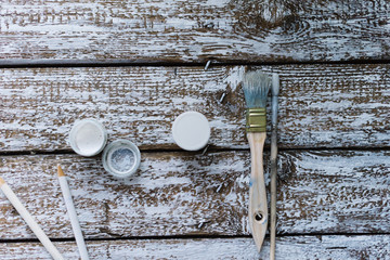 Brushes on a wooden painted white background.
