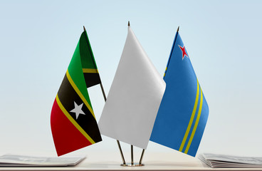 Flags of Saint Kitts and Nevis and Aruba with a white flag in the middle