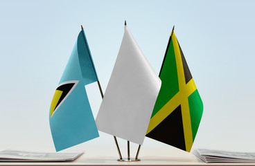 Flags of Saint Lucia and Jamaica with a white flag in the middle