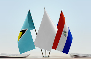 Flags of Saint Lucia and Paraguay with a white flag in the middle