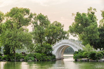 Fototapeta na wymiar Evening view of white twin marble bridge on lake, Guilin