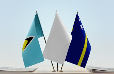 Flags of Saint Lucia and Curacao with a white flag in the middle