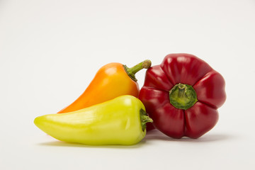 Three beautiful sweet peppers on a white background