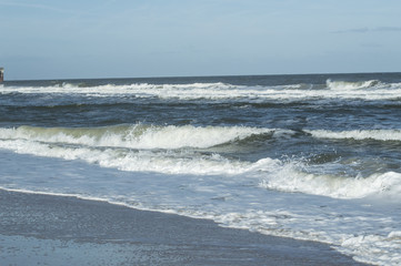 The waves crashing onto the beach