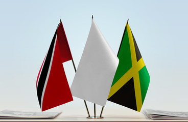 Flags of Trinidad and Tobago and Jamaica with a white flag in the middle