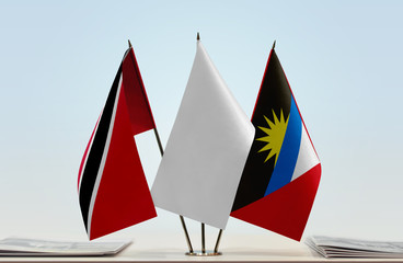 Fototapeta na wymiar Flags of Trinidad and Tobago and Antigua and Barbuda with a white flag in the middle