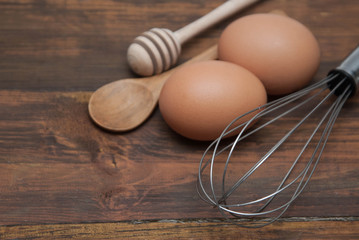 Baking Background with Raw Eggs, Dark Wooden table. Pastry making and bakery concept, top view, copy space. Minimalist Style. View from Above.