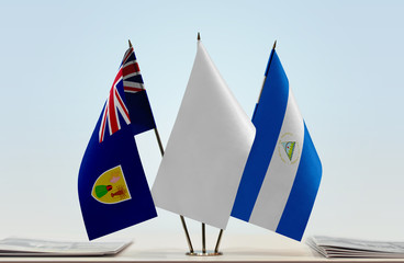 Flags of Turks and Caicos Islands and Nicaragua with a white flag in the middle