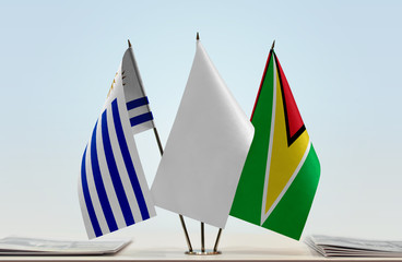 Flags of Uruguay and Guyana with a white flag in the middle