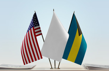 Flags of USA and Bahamas with a white flag in the middle