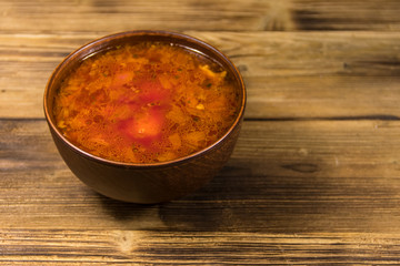 Ukrainian and Russian traditional beetroot soup - borscht on wooden table