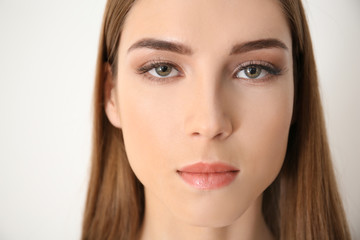 Obraz premium Young woman with eyelash loss problem on white background