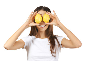 Beautiful young woman with ripe lemons on white background