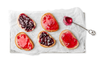 Delicious toasts with sweet jams on white background