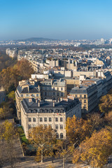Paris, panorama from the Arc de Triomphe, aerial view, beautiful buildings and roofs in a charming area, the Mont Valerien in background

